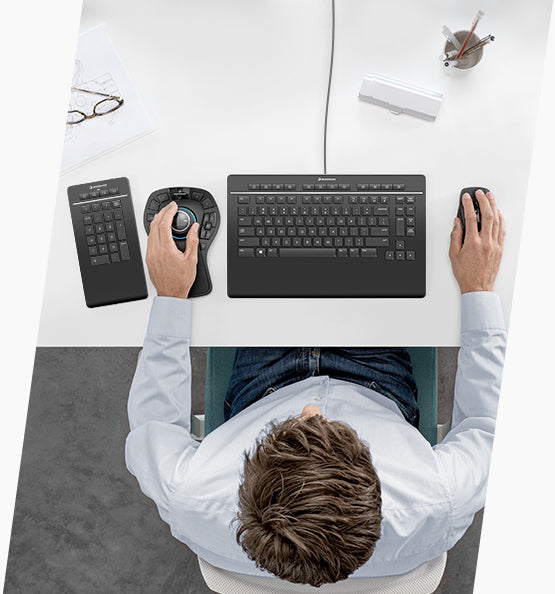 Person using 3dconnexion ergonomic keyboard and 3d mouse setup at a desk